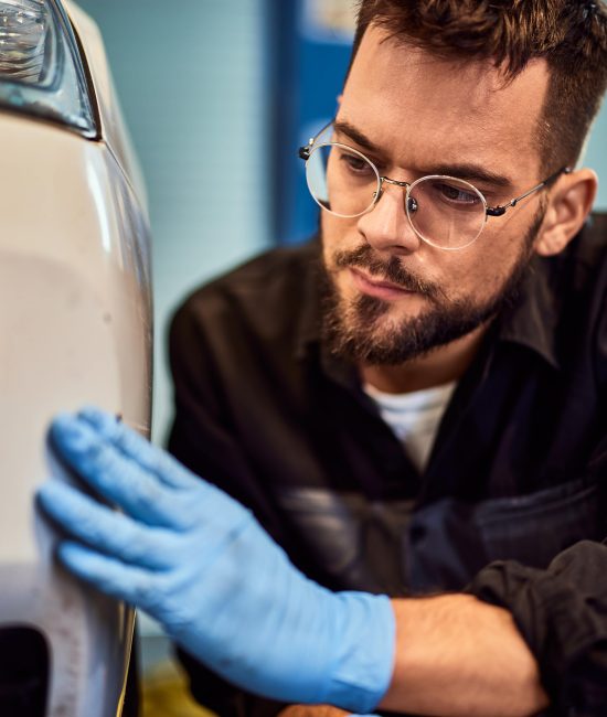 a-male-mechanic-wearing-gloves-is-looking-at-the-s-2025-08-27-18-43-32-utc-min a-male-mechanic-wearing-gloves-is-looking-at-the-s-2025-08-27-18-43-32-utc-min
